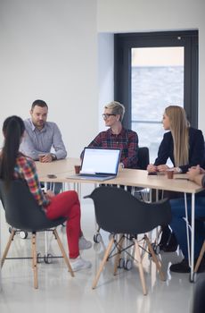 startup business team on meeting in modern bright office interior brainstorming, working on laptop and tablet computer