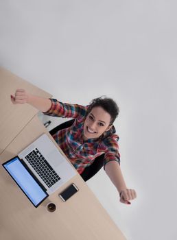 top view of young business woman working on laptop computer in modern bright startup office interior