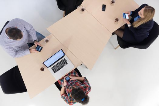 top view of multi ethnic startup business people group on brainstorming meeting in modern bright office interior