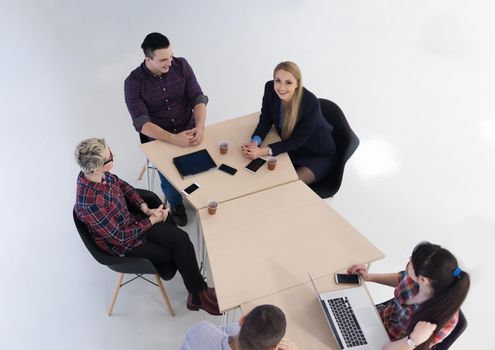 top view of multi ethnic startup business people group on brainstorming meeting in modern bright office interior