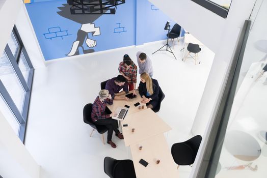 top view of multi ethnic startup business people group on brainstorming meeting in modern bright office interior