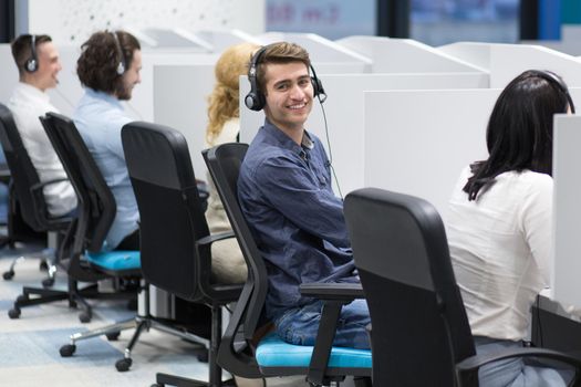 group of young business people with headset working and giving support to customers in a call center office