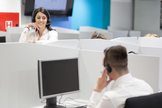 young smiling female call centre operator doing her job with a headset