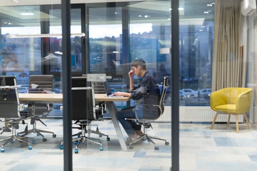 A time for relax. Young tired casual businessman relaxing at the desk in his office