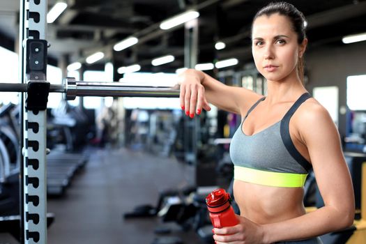 Sporty woman resting, having break after doing exercise