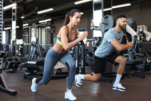 Attractive sport couple doing fitness at gym