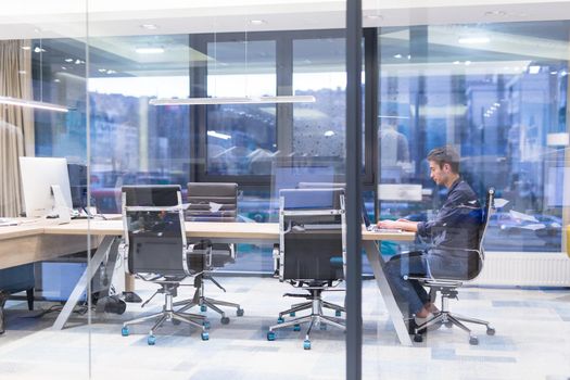 A time for relax. Young tired casual businessman relaxing at the desk in his office