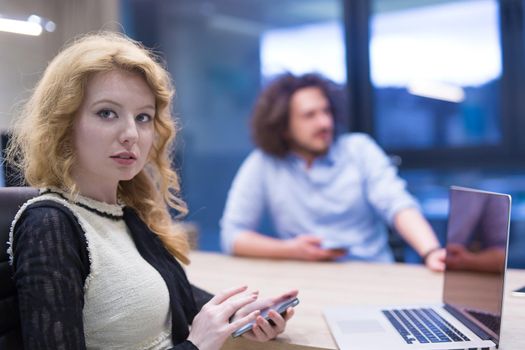 female manager using cell telephone in startup office interior