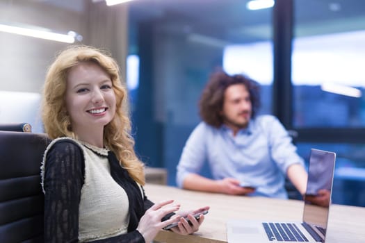 female manager using cell telephone in startup office interior