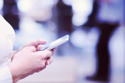 female manager using cell telephone in startup office interior