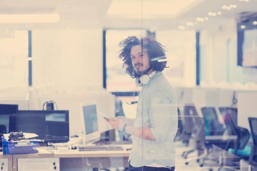 young casual businessman using tablet computer in startup office