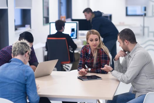 startup business team on meeting in modern bright office interior brainstorming, working on laptop and tablet computer