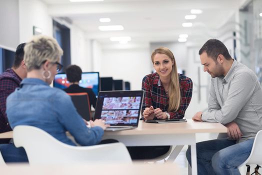 startup business team on meeting in modern bright office interior brainstorming, working on laptop and tablet computer