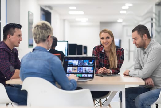 startup business team on meeting in modern bright office interior brainstorming, working on laptop and tablet computer