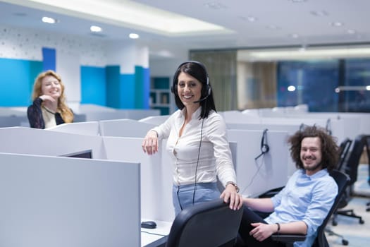 group of young business people with headset working and giving support to customers in a call center office