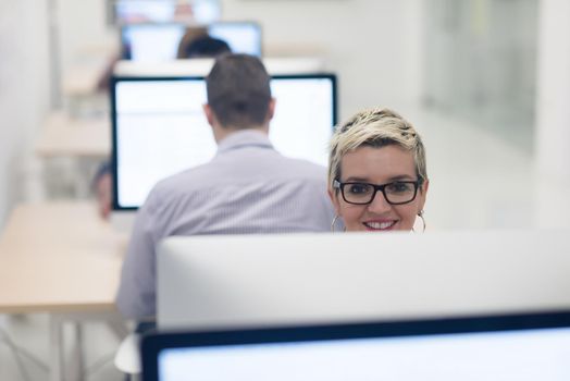 startup business, woman  working on dektop  computer at creative modern office relaxing and have fun