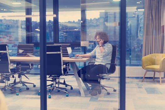 Young casual businessman using smartphone in the startup office