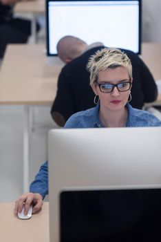 startup business, woman  working on dektop  computer at creative modern office relaxing and have fun