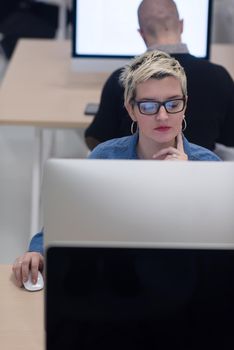 startup business, woman  working on dektop  computer at creative modern office relaxing and have fun