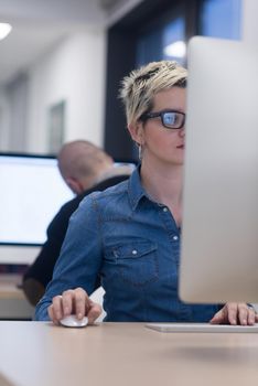 startup business, woman  working on dektop  computer at creative modern office relaxing and have fun