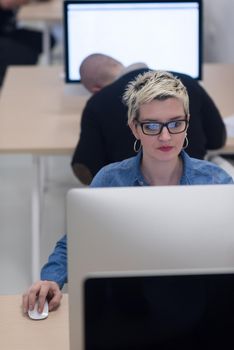 startup business, woman  working on dektop  computer at creative modern office relaxing and have fun