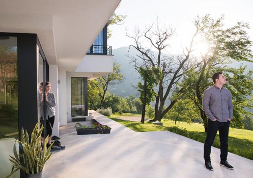 portrait of a young handsome successful man in front of his luxury home villa