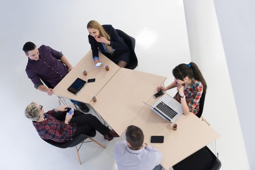 top view of multi ethnic startup business people group on brainstorming meeting in modern bright office interior