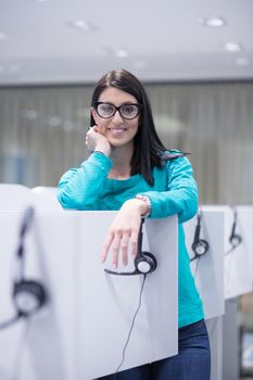 young smiling female call centre operator doing her job with a headset