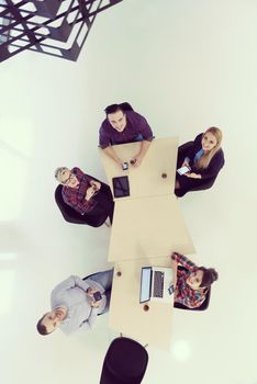 top view of multi ethnic startup business people group on brainstorming meeting in modern bright office interior