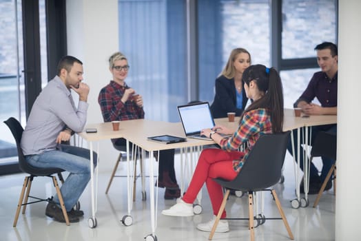 startup business team on meeting in modern bright office interior brainstorming, working on laptop and tablet computer