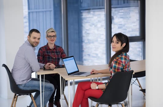 startup business team on meeting in modern bright office interior brainstorming, working on laptop and tablet computer