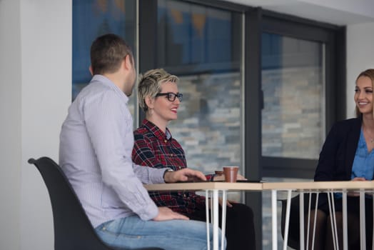 startup business team on meeting in modern bright office interior brainstorming, working on laptop and tablet computer