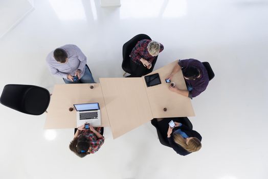 top view of multi ethnic startup business people group on brainstorming meeting in modern bright office interior