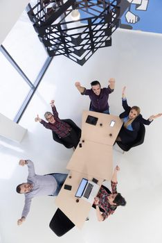 top view of multi ethnic startup business people group on brainstorming meeting in modern bright office interior