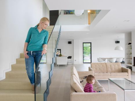 portrait of a young beautiful woman on the stairs in her luxurious home