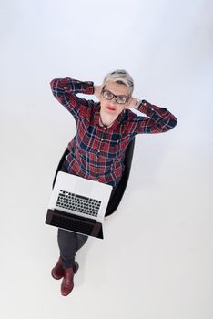 top view of young business woman working on laptop computer in modern bright startup office interior, sitting on floor