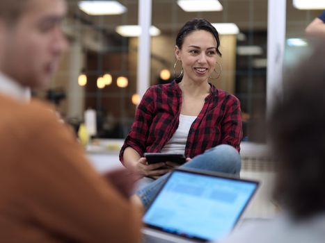 business people group in modern office have a team meeting and brainstorming while working on tablet or laptop  presenting ideas and take notes