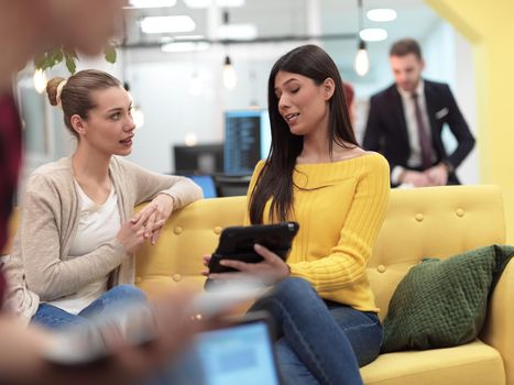 group of female friends having a team meeting and discussion about project or gossip chatting in modern startup business  open space coworking office