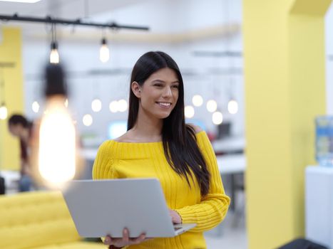 young business woman at work in creative modern coworking startup open space office using laptop compurer