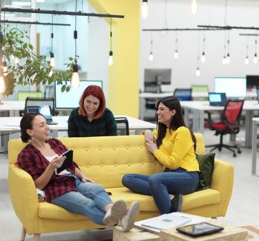 group of female friends having a team meeting and brrainstorming about business  project in modern startup open space coworking office
