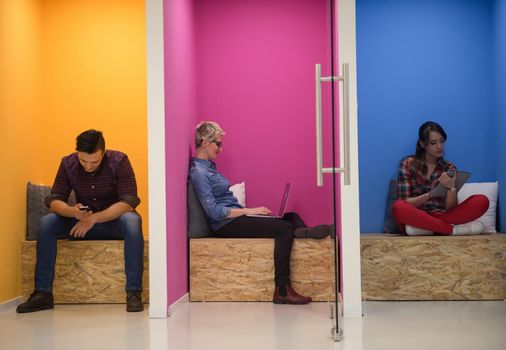 group of young business people having fun, relaxing and working in creative room space at modern startup office