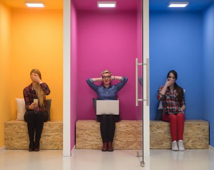 group of young business people having fun, relaxing and working in creative room space at modern startup office