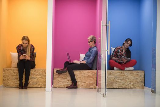 group of young business people having fun, relaxing and working in creative room space at modern startup office