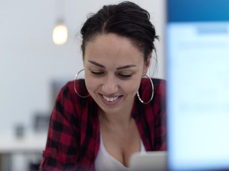 business woman portrait  in open space startup coworking office as influencer  using smart phone, tablet computer