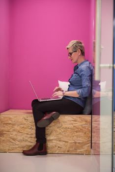 young woman in crative box working on laptop computer, startup business modern office room  interior