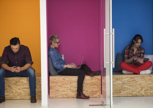 group of young business people having fun, relaxing and working in creative room space at modern startup office