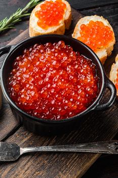 Canape with Red Salmon Caviar, for New Year, on old dark wooden table background