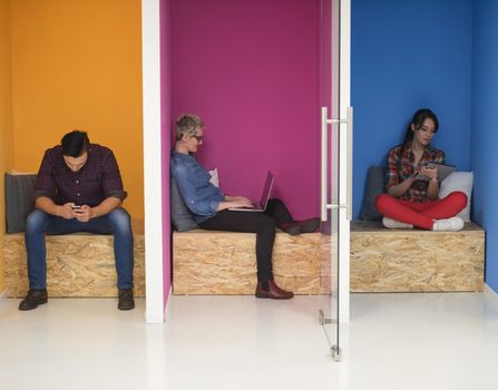 group of young business people having fun, relaxing and working in creative room space at modern startup office