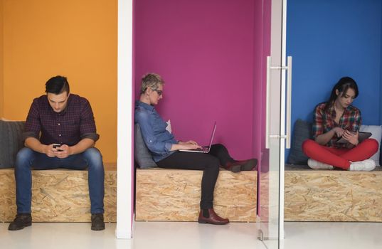 group of young business people having fun, relaxing and working in creative room space at modern startup office