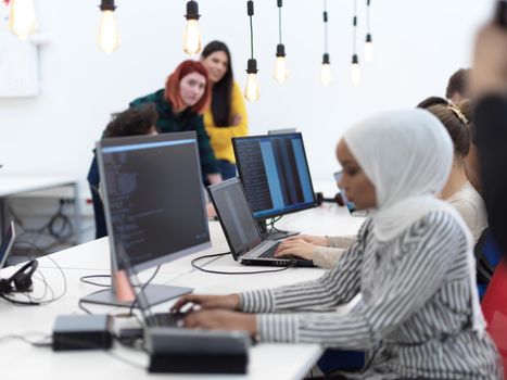 african black woman wearing hijab as part of creative business team creative freelancers  in modern coworking open space startu office